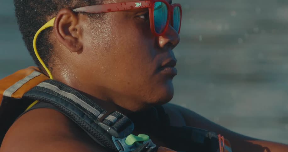 Portrait of a focused person rowing with an oar