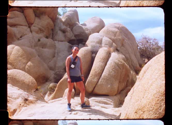 Woman smiling in the middle of a natural area with rocks
