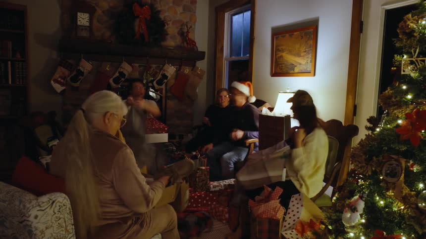 Family in a christmas room exchanging gifts