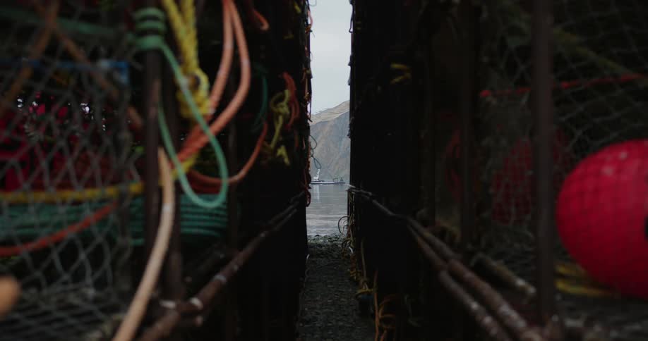 Fishing boat moving between crab traps in Alaska