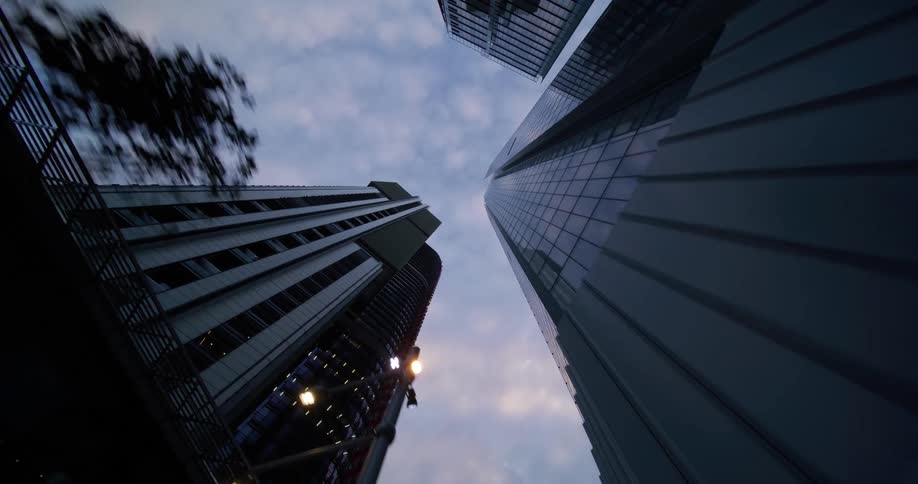 Looking up on a cloudy day with modern skyscrapers