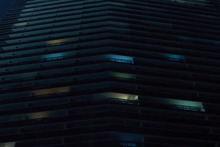 Building lights turn off in a skyscraper as the night passes
