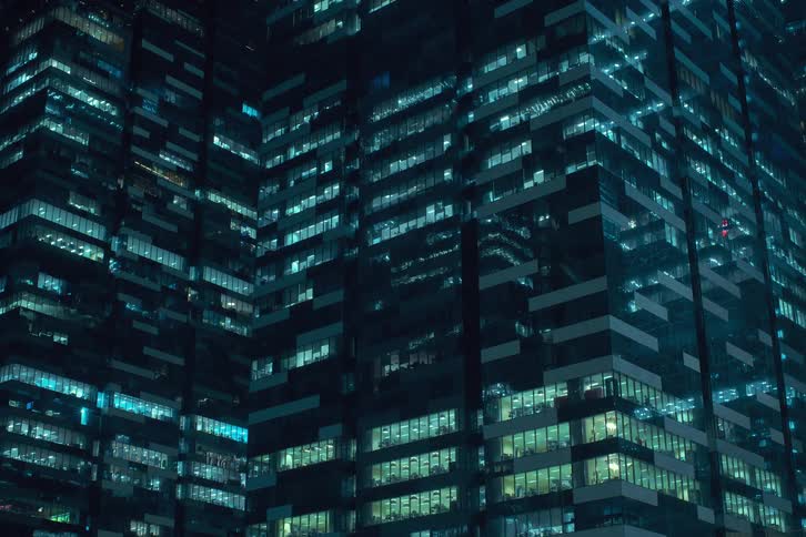 People in the office are moving around at night