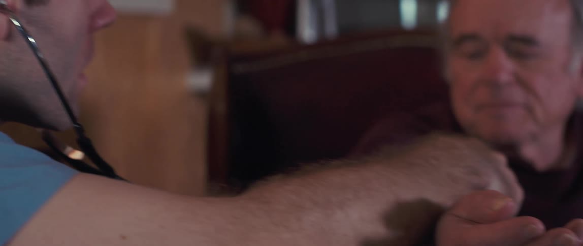 Nurse checking the heartbeat of an elderly man