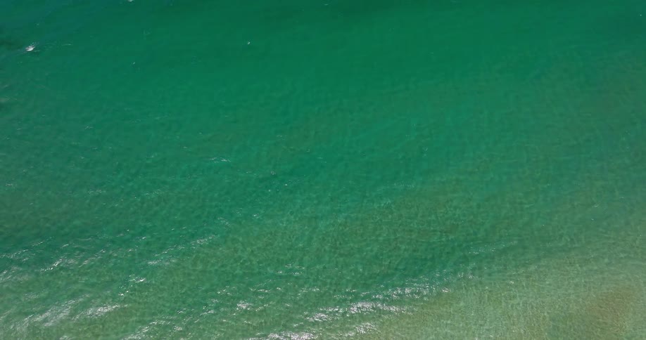 Aerial view of an ocean with calm turquoise blue waters