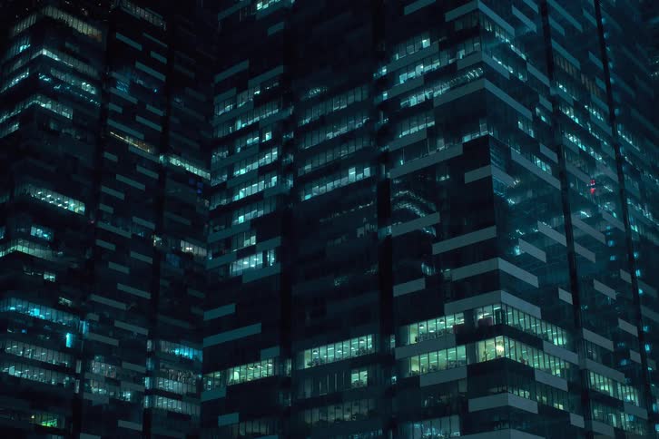 A clip of a high rise building as the lights turn off together