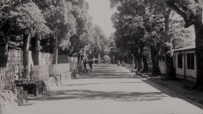 People walking through a forest and a temple during the day