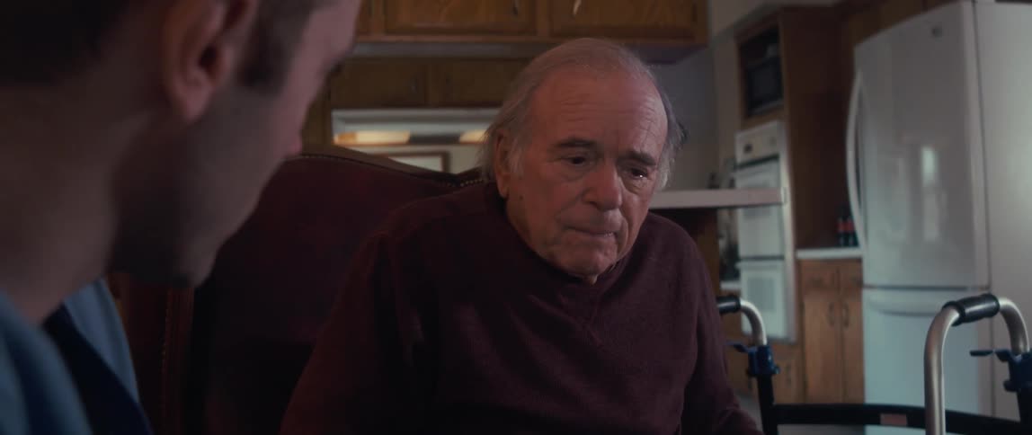 A doctor is speaking with a patient in his home