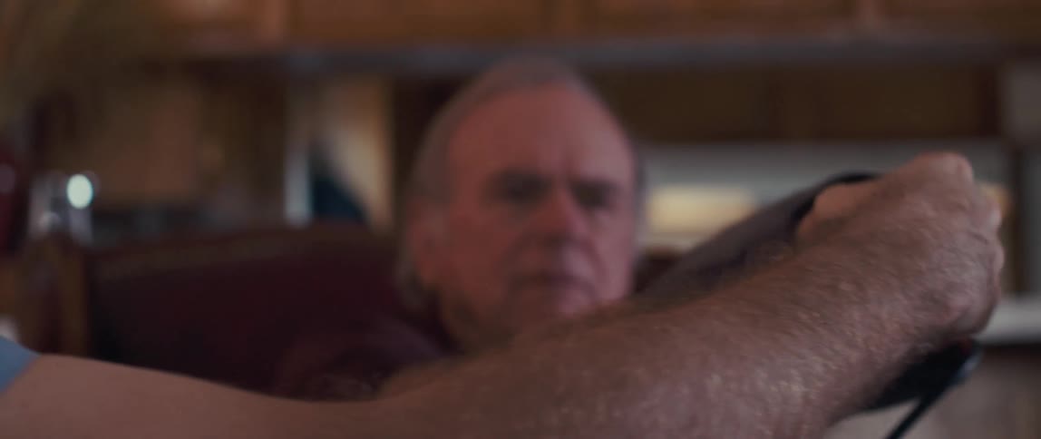 Male medical professional takes the blood pressure of an elderlyman during a home healthcare visit