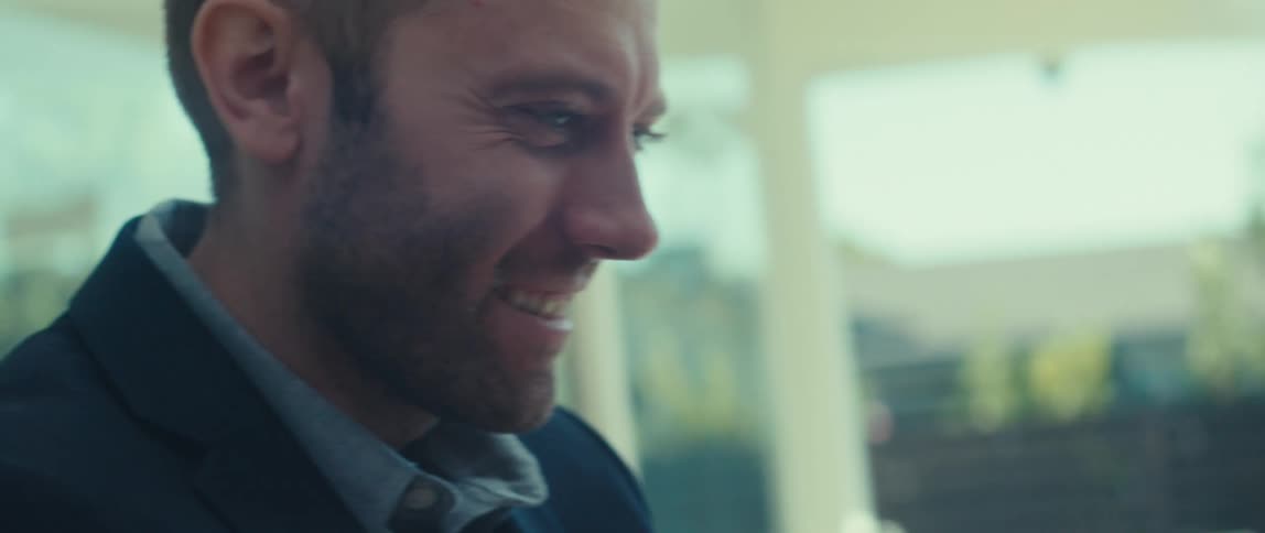 A man looks up smiling