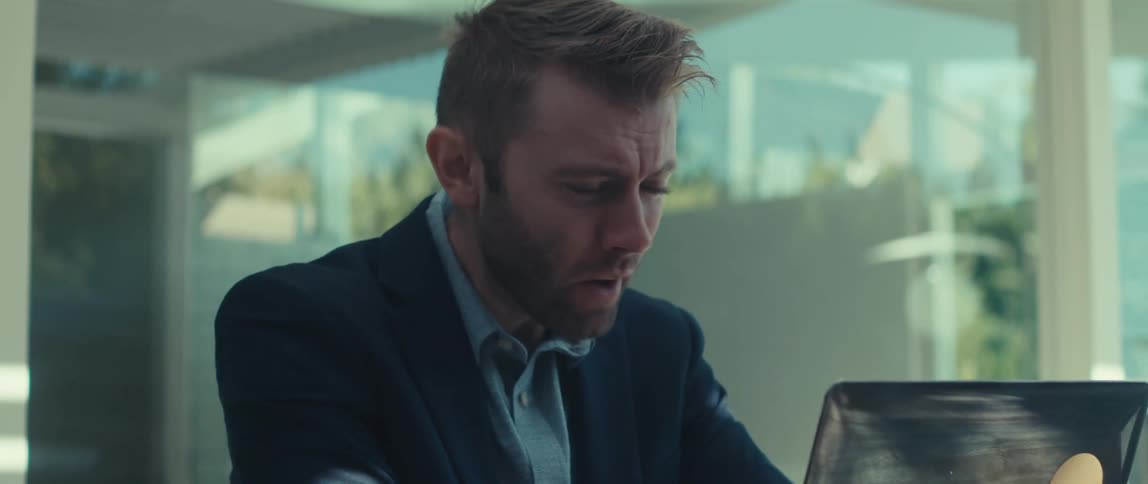 Man getting stressed making hand gestures while sitting in front of a laptop