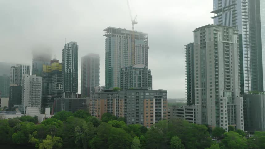 Panorama of residential and commercial buildings and others under construction on a foggy day