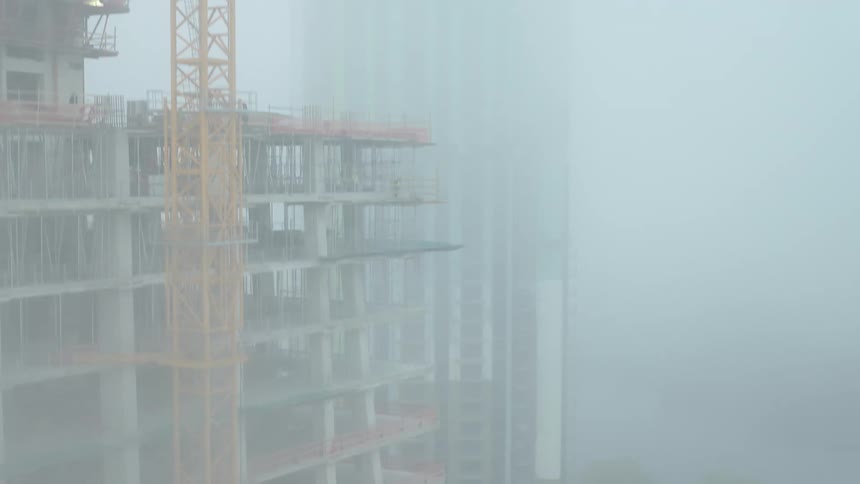 A clip of an uncompleted building filled with fog