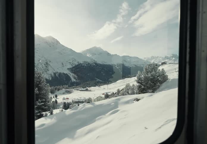 Interior view of a cable car ascending a snowy mountain