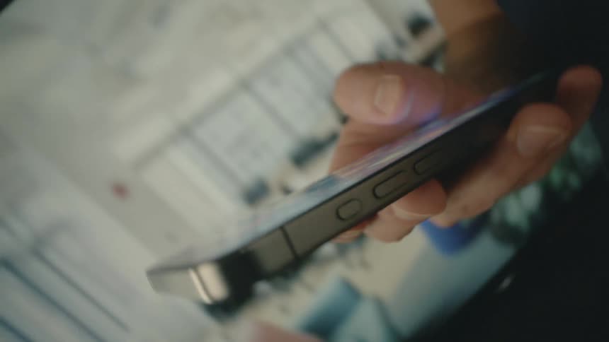 A man is holding his cell phone