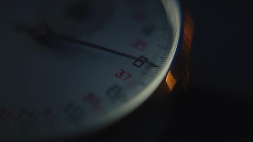 The hand on a stopwatch is spinning around