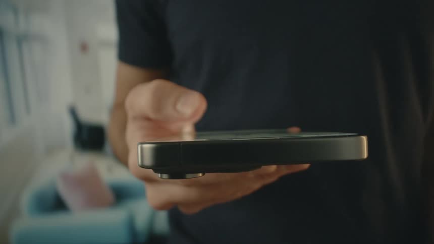A man uses his thumb to scroll on a phone