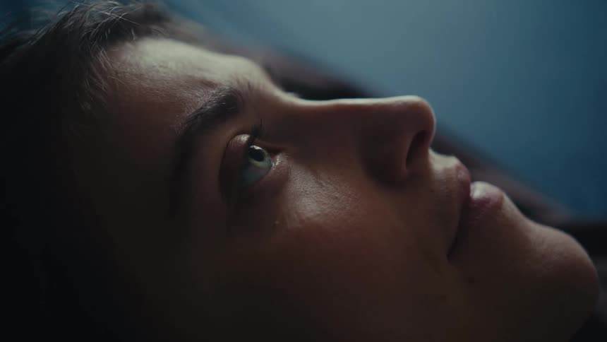 Closeup of a woman blinking and staring