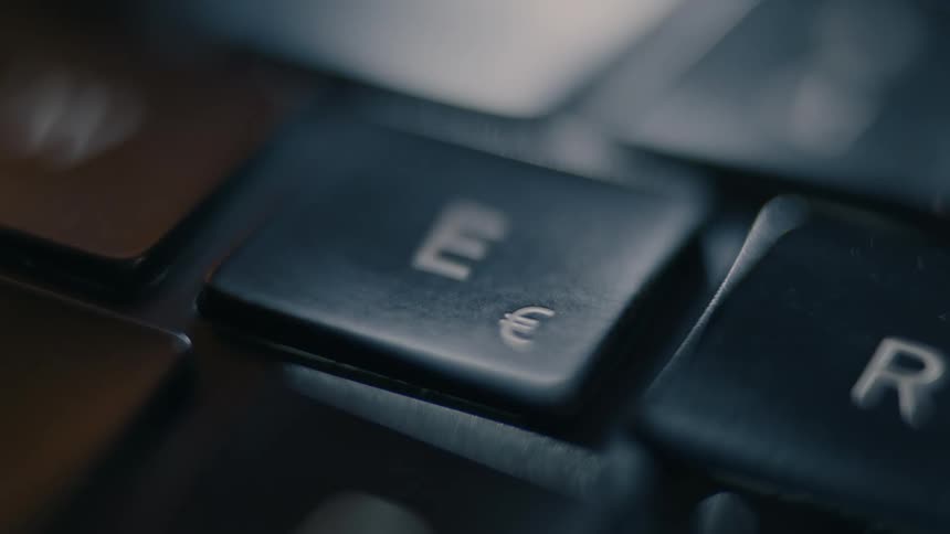 A close up of a finger pressing a key on a keyboard