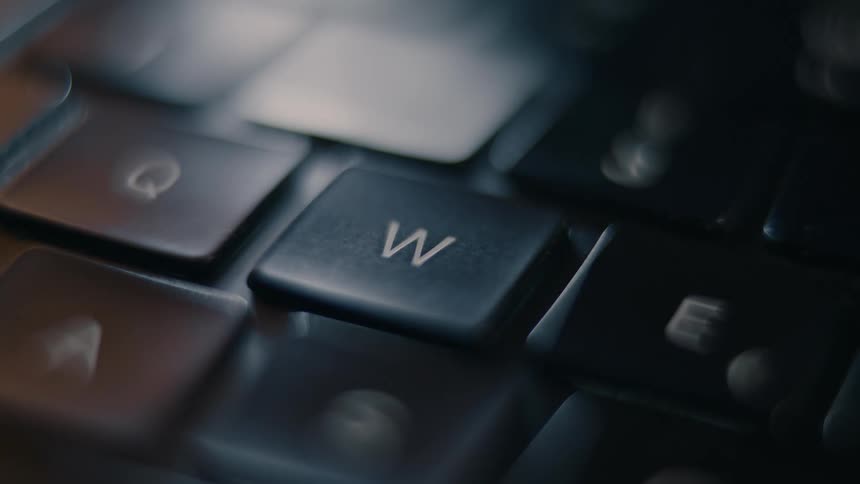 A footage of a person pressing a key on the keyboard