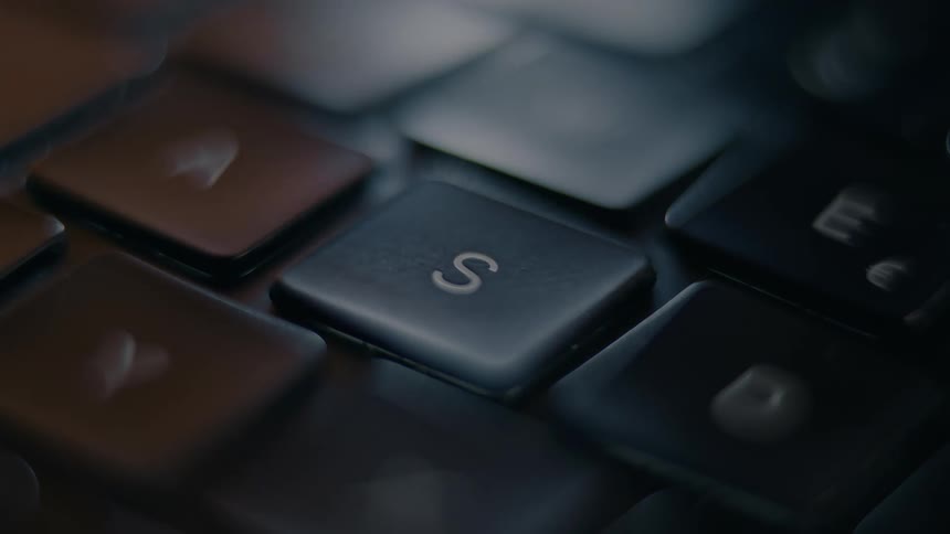A close up clip of a person typing on a keyboard