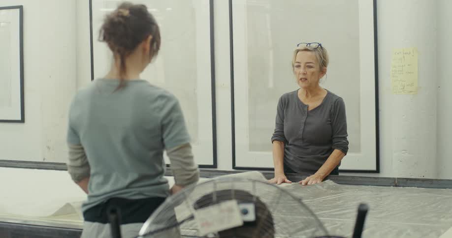 Two women working on a fabric