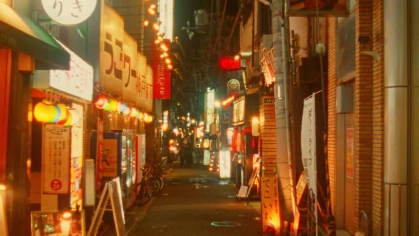Alley with asian shops and restaurants lit up at night