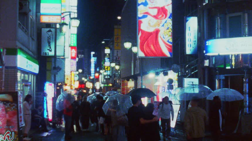 People carry umbrellas as they walk in the rain