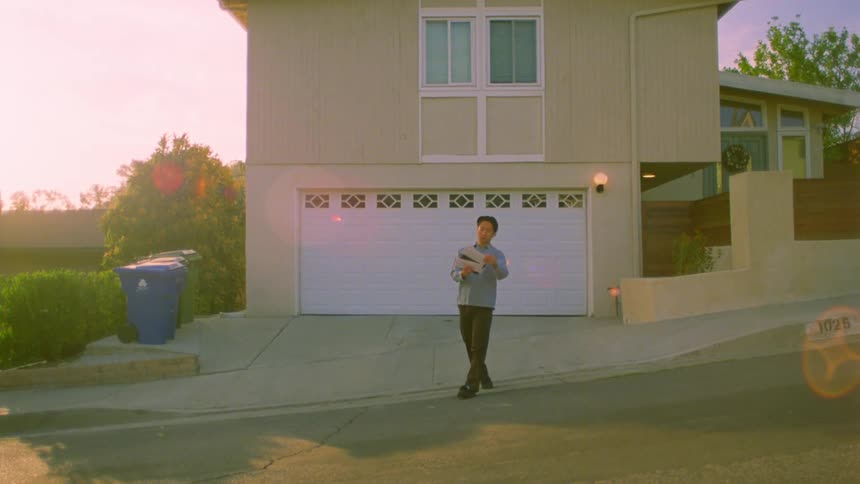 A man waves around mail as he dances