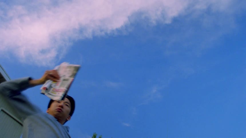 Man dancing outdoors while holding mail