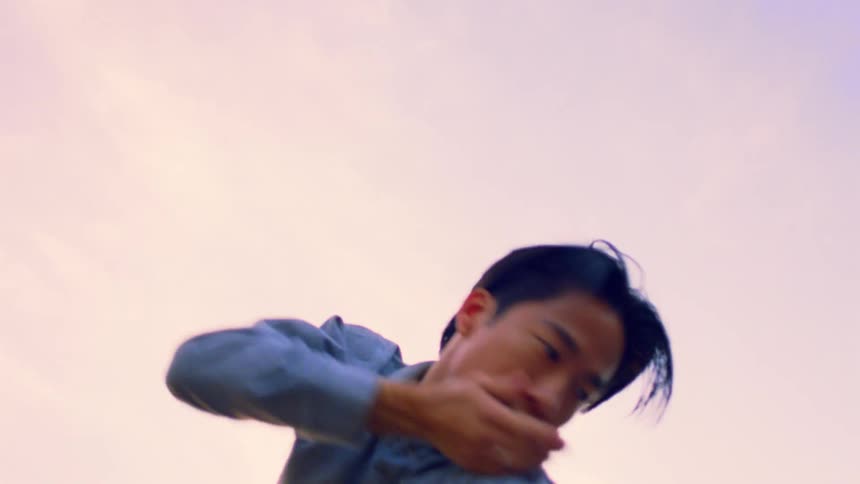 A man is doing interpretive dance outdoors