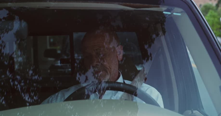 A man parks a vehicle then gets out of it