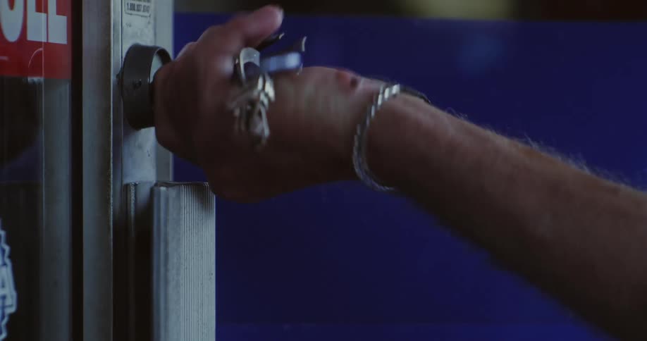 Hand with key putting into a door