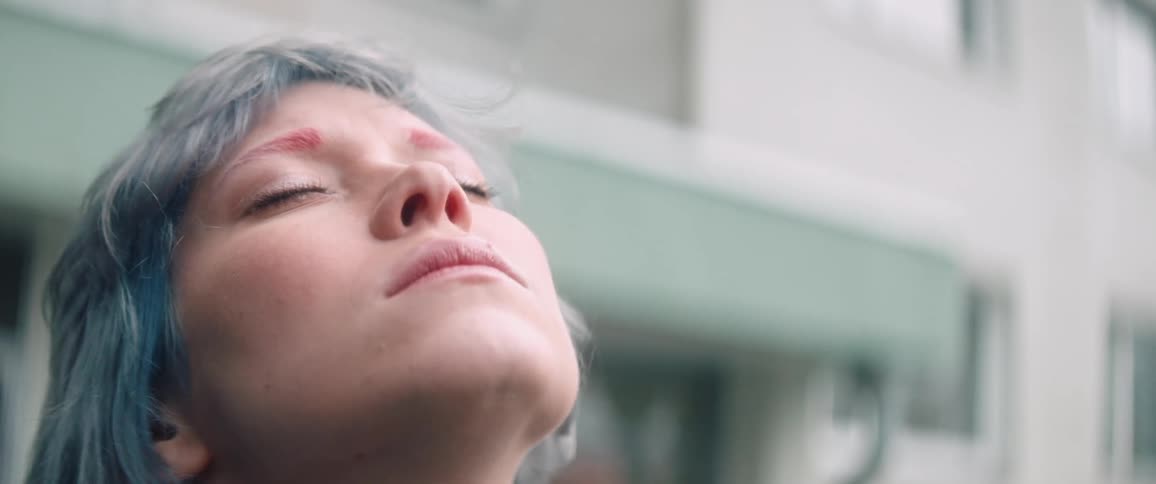 A woman leans her head back and closes her eyes