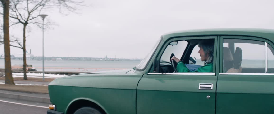 Two women have fun while driving a car