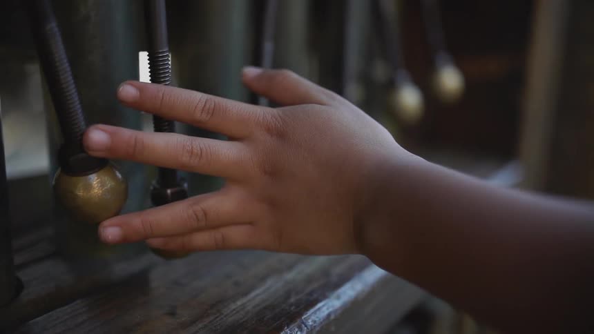 Hand glides across metal objects