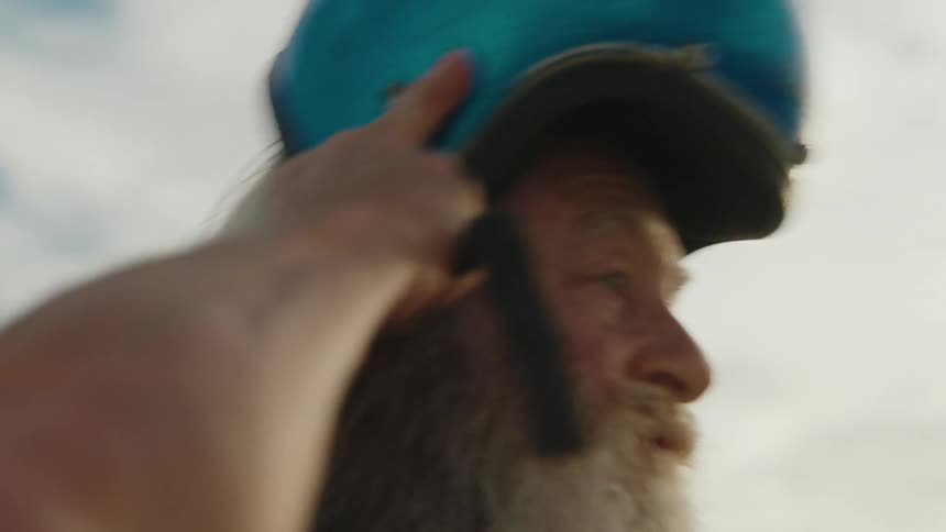 A clip of an old man putting on an helmet