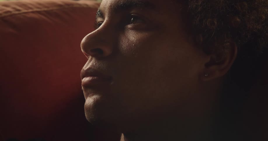 A man is looking forward while sitting