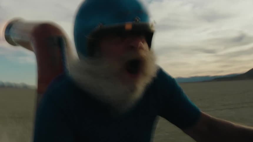 A man is riding a machine across a desert