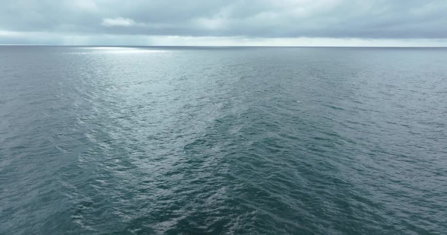 Aerial of an ocean on a mostly cloudy day