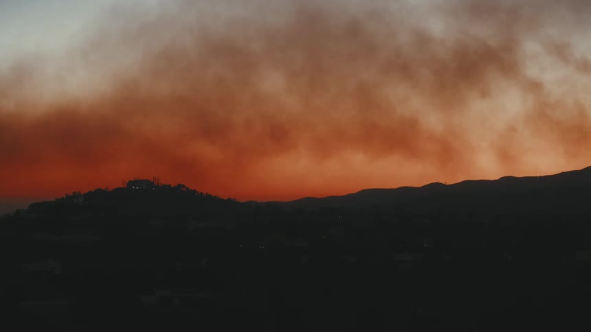 Mountain silhouette with reddish sky