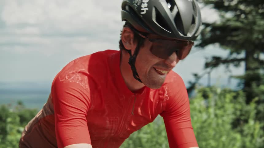 A gravel cyclist struggles as he makes his way up a hill