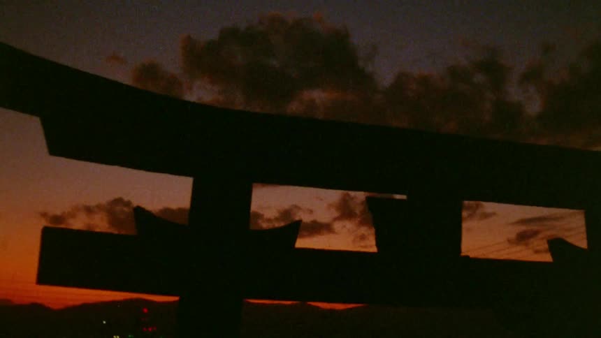 The sun is setting behind the structure
