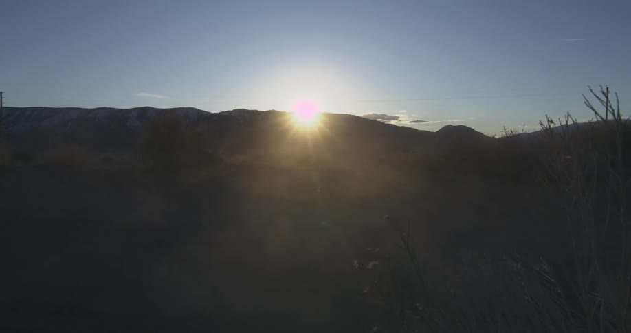 A vehicle passes by the mountains fast