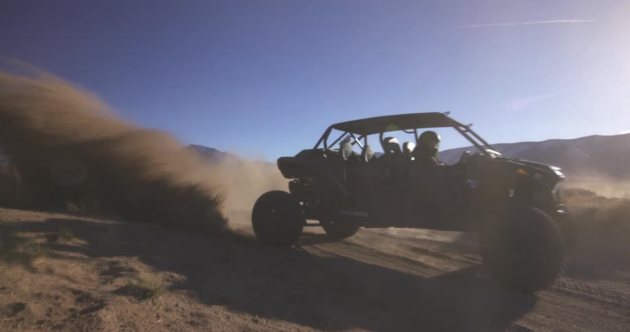 The off road vehicle leaves a dust cloud behind