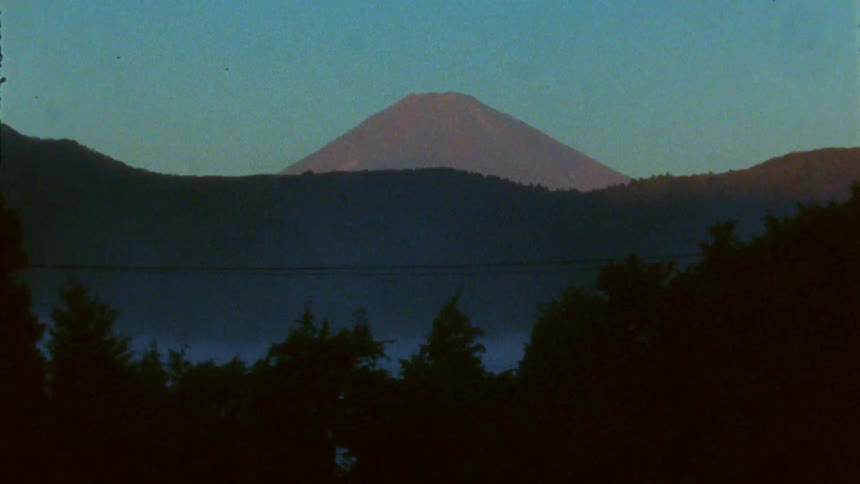 Forest covers the lower part of a mountain range