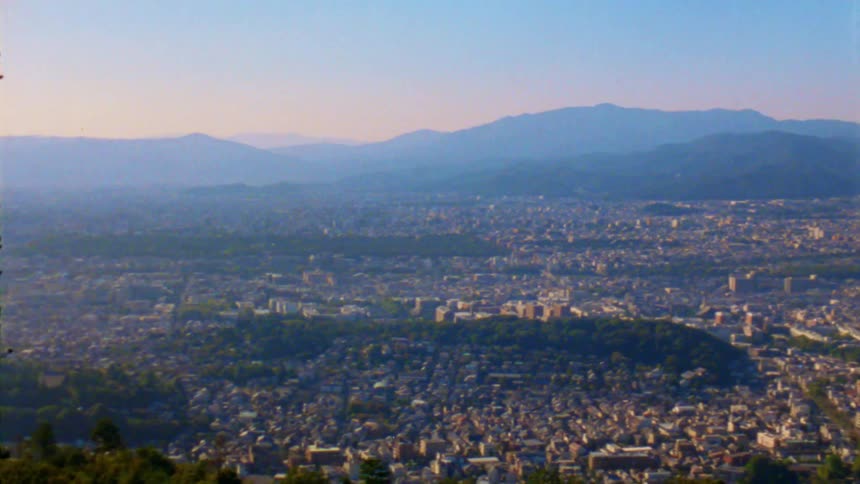 A city is revealed from a mountaintop view