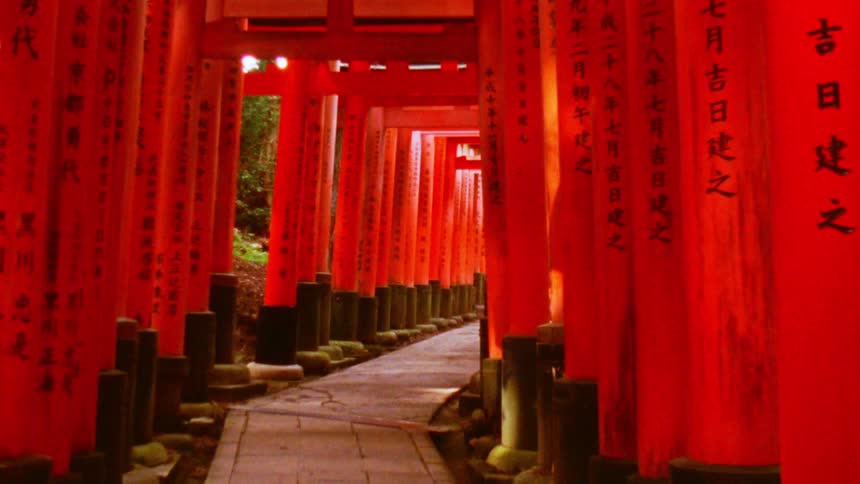 Red decorations line a pathway with arches