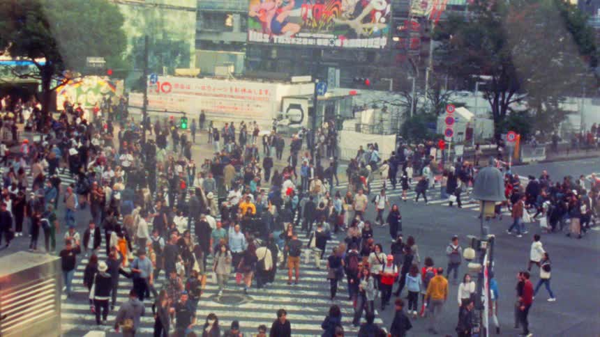 The iconic shibuya crossing in tokyo is a sea of people crossing the street in all directions