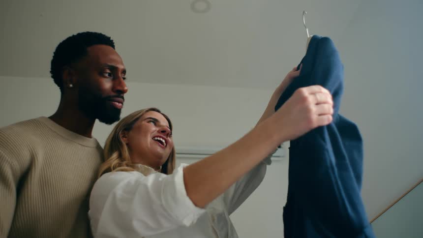 Happy couple looking at a piece of clothing together